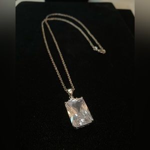 925 SS 24” long chain. Large Emerald cut CZ set in 925 SS raised cage 1”x 1/2”